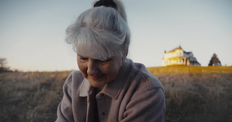 An elderly woman outside
