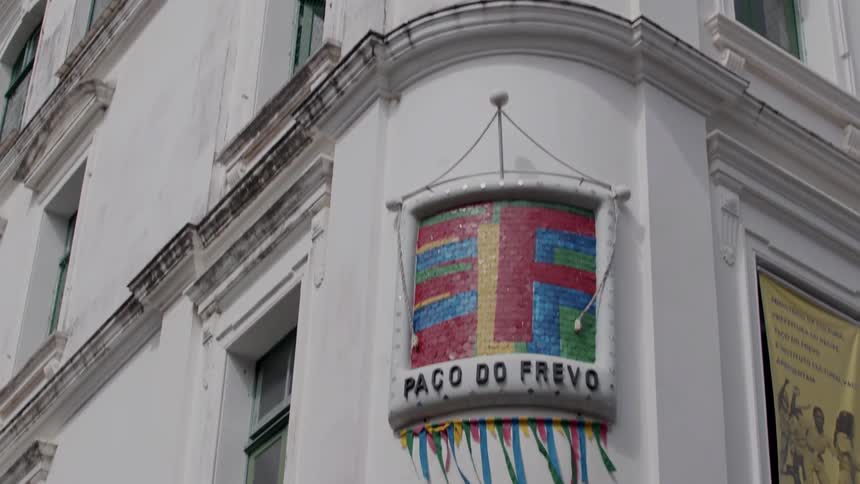 Corner of a building with a banner above it