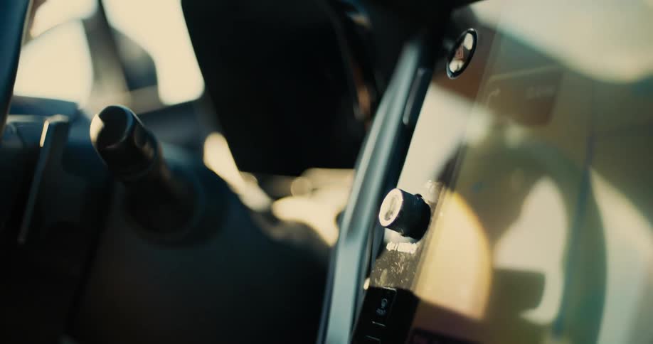Hand with rings adjusts the control panel inside a car