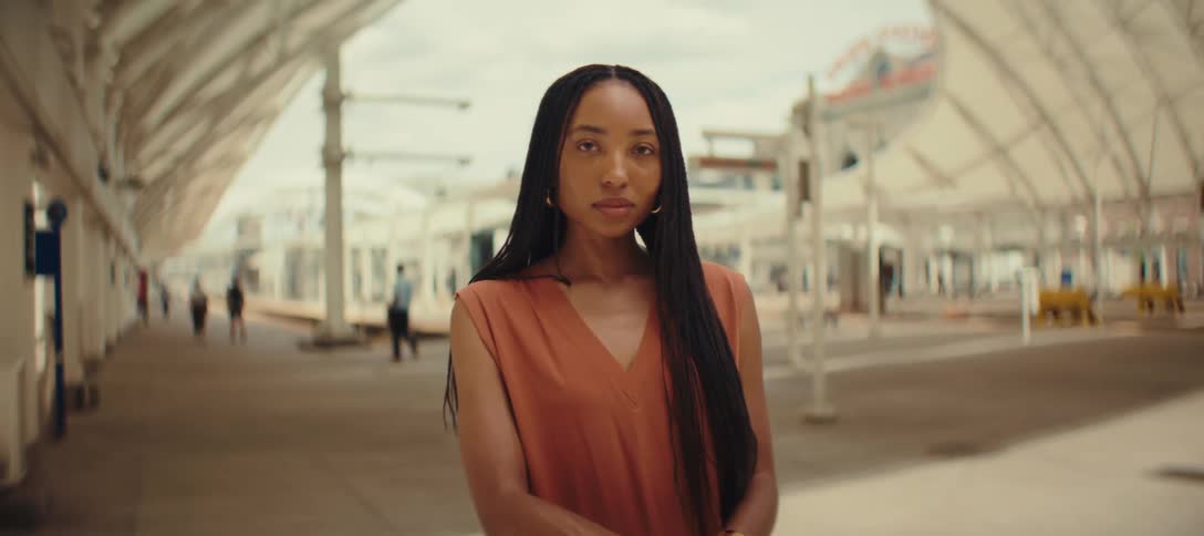 A woman stands on the walkway in the city