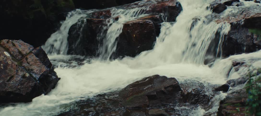 Water flows fast over rocks in the river