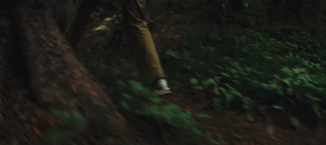 A closeup of a persons feet as they walk along a dirt path