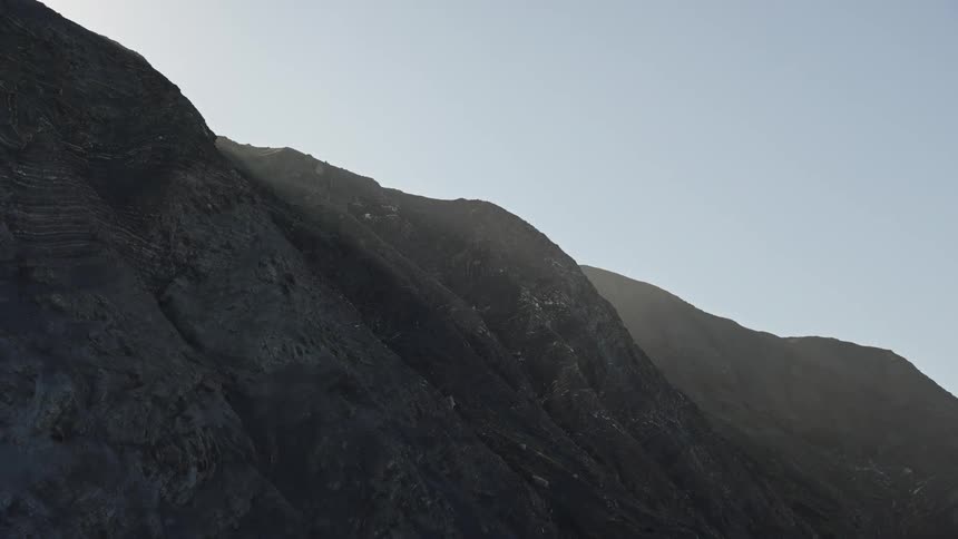 Rocky hillside lit by the soft light of dawn