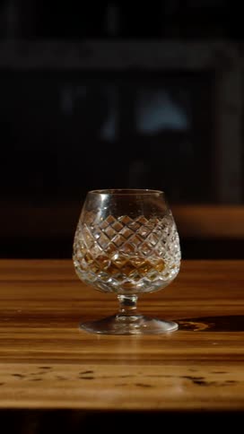 Cut crystal glass with drink on a wooden table