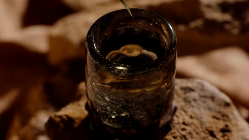 Liquid slowly drips into the glass