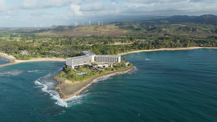 Aerial view of a luxury resort on an island surrounded by ocean