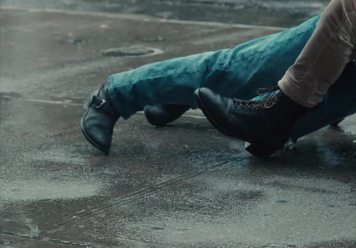 Two people roll around on the sidewalk