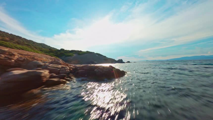 The water bounces off the rocks on the island