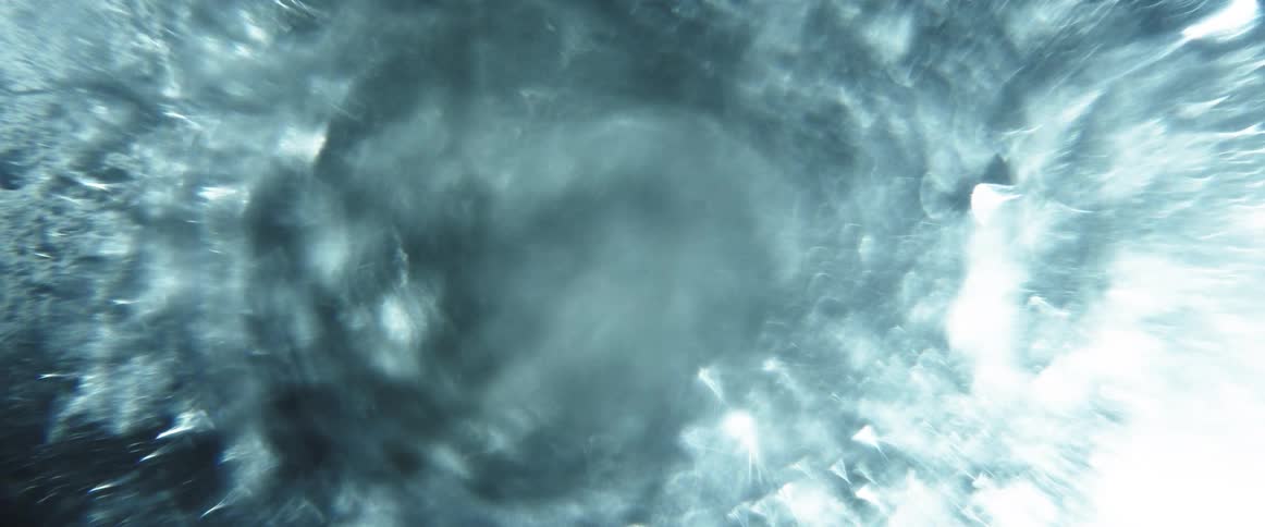 A bright light refracts in a circular pattern which creates a surreal appearance