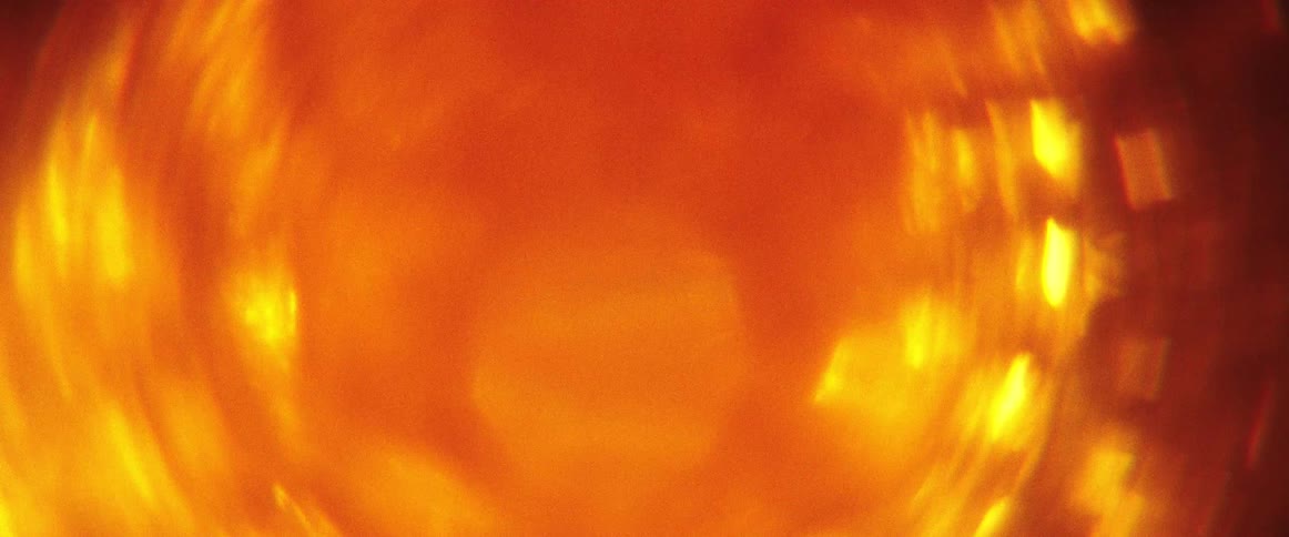Glowing orange mixture rotates against a darker background