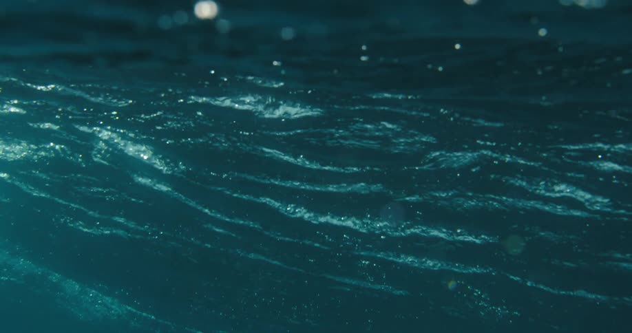 Based on the video there is a lowangle shot of the ocean with waves rising and falling the sky is overcast with clouds