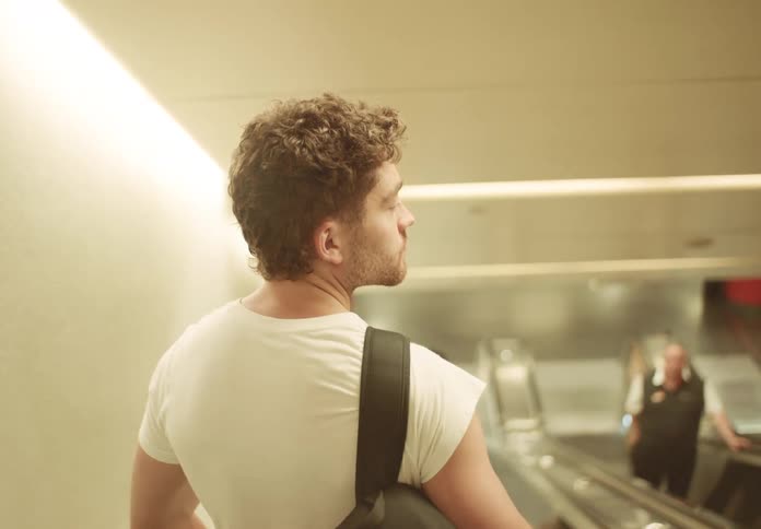 A man goes down an escalator