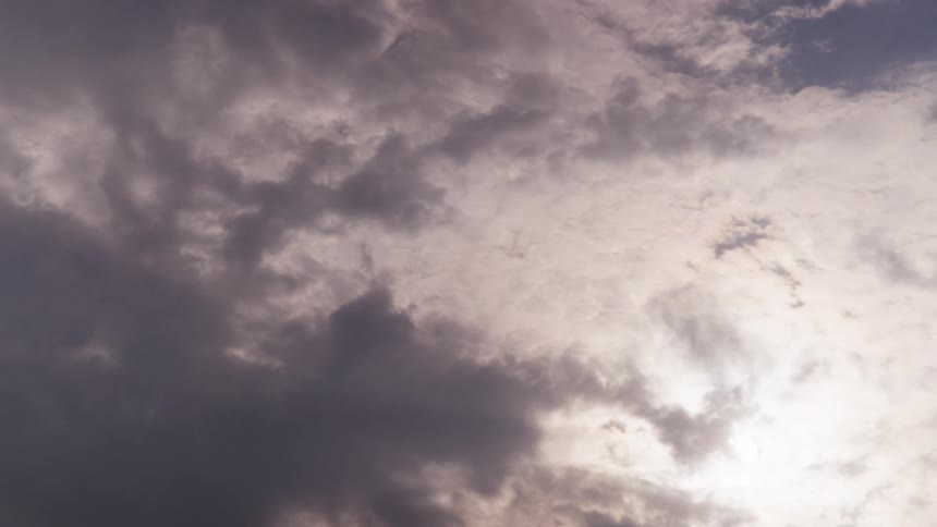 Multiple clouds pass overhead as sunlight occasionally shines through