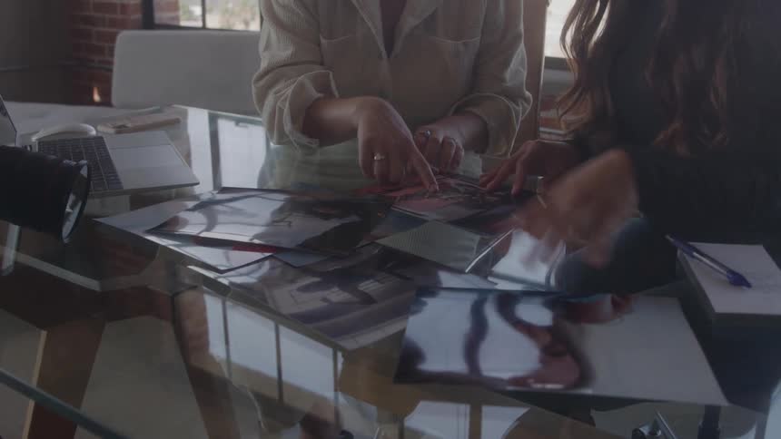 Two people review photos on a table