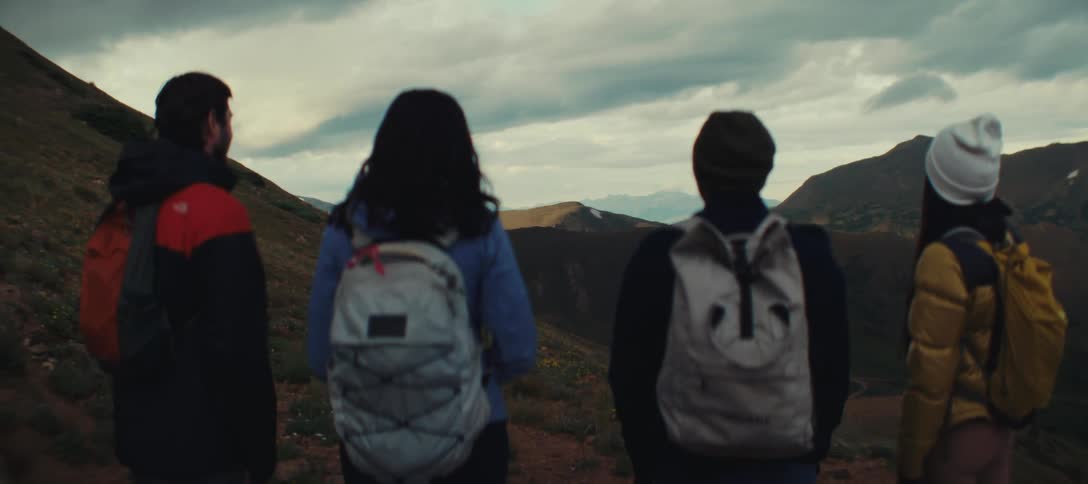 A group are backpacking through the mountains together