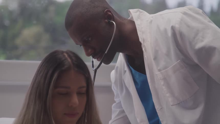 Doctor listens attentively to a patient using a stethoscope