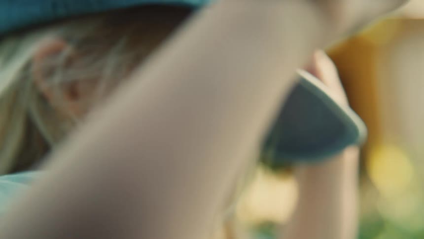 A closeup side profile shot of a young childs head and shoulder with blonde hair
