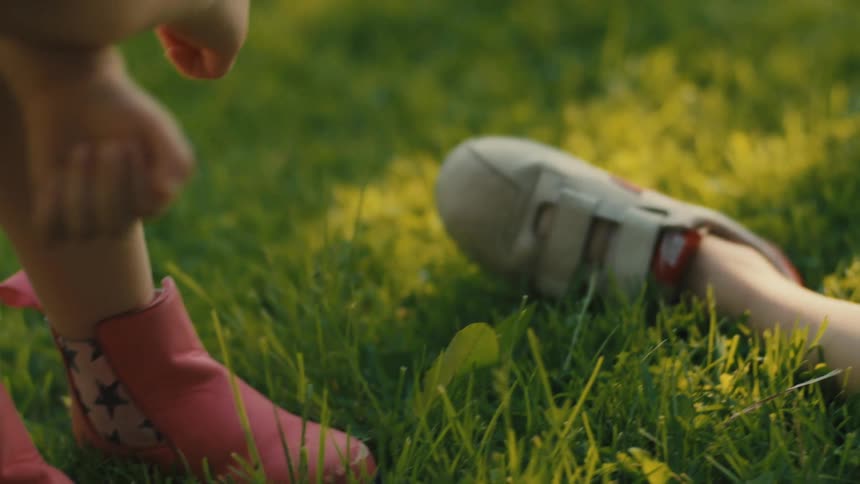Two children are on the green grass