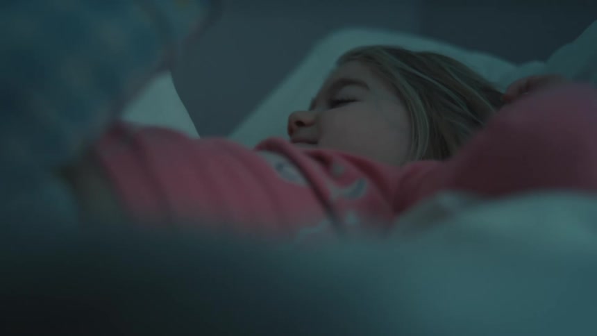 A closeup of a girl in her bed on a wake up routine