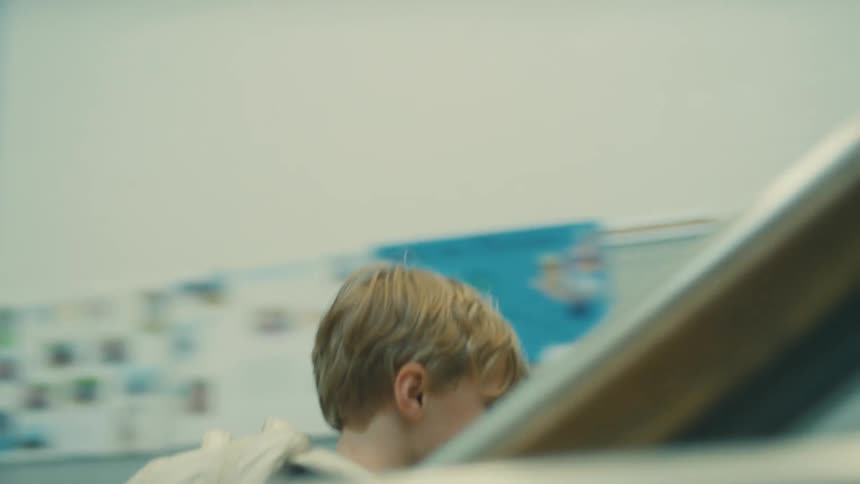 The boy climbs the stairs in the school