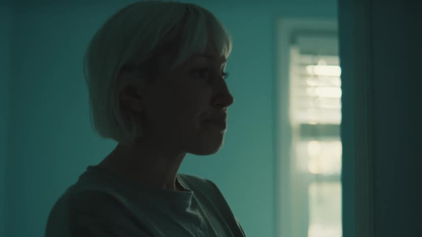 Blonde woman crying alone at home during the daytime walks away