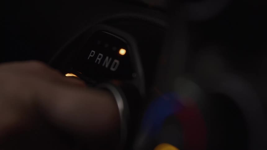 Hand adjusting the automatic gear selector in a vehicle