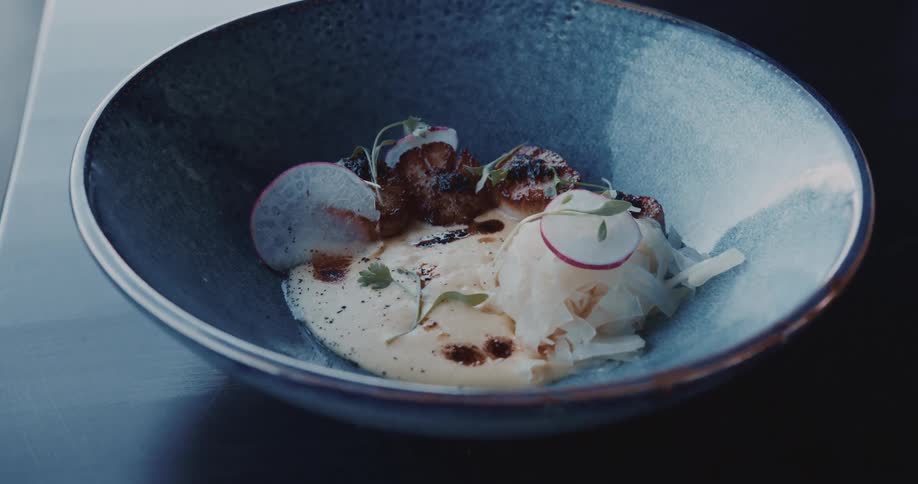 Rounded dish with cream and squid