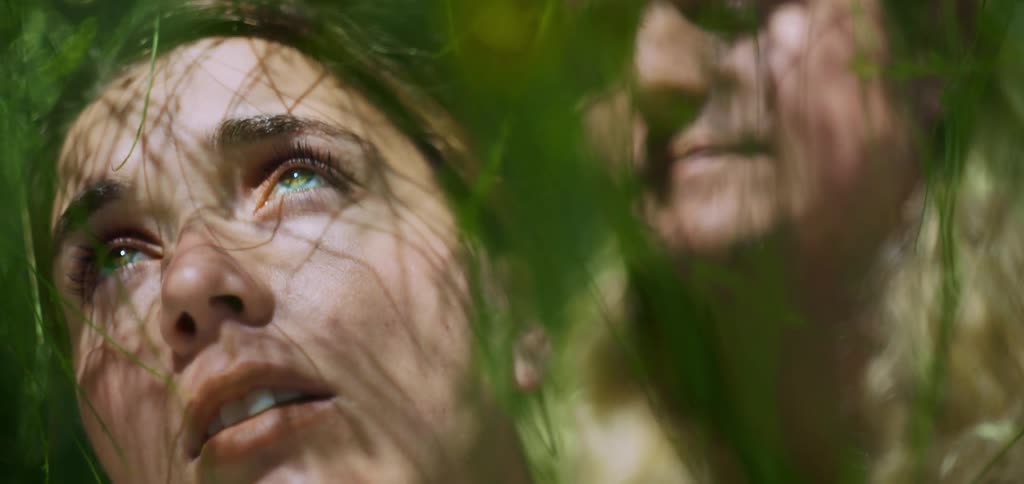 Faces framed by branches lit by sunlight highlighting contemplative expressions