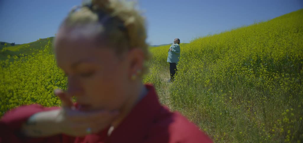 A couple women dancing in a field