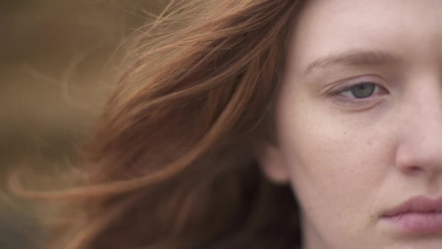 Woman with red hair blowing in the wind