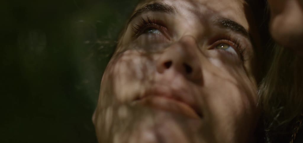 Close up portrait of a young woman staring into the sky contemplatively while outdoors