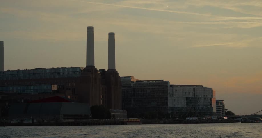Battersea power station stands out against the orange sunset sky