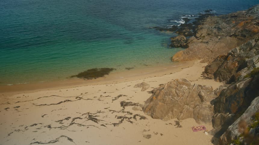 Secluded beach with golden sand rocks and turquoiseblue sea
