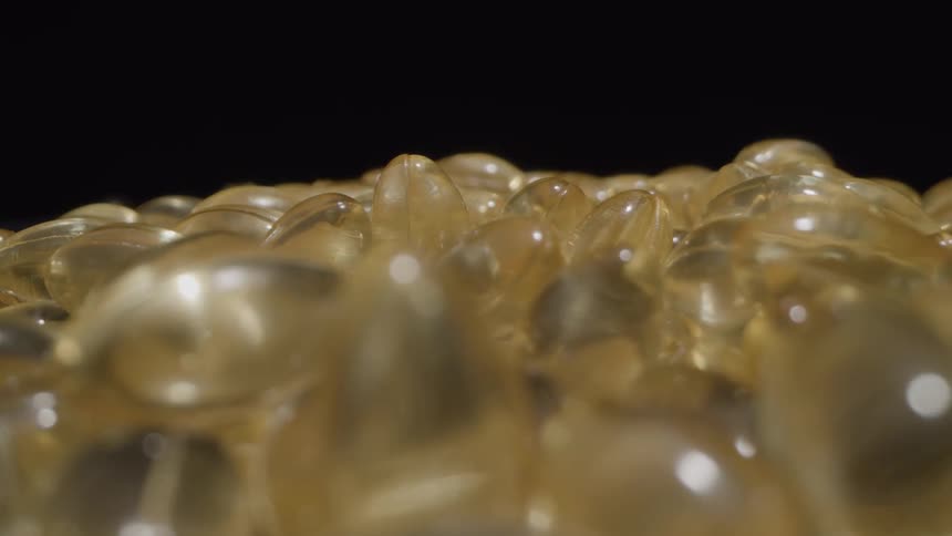 Light reflects off a stack of gel caps