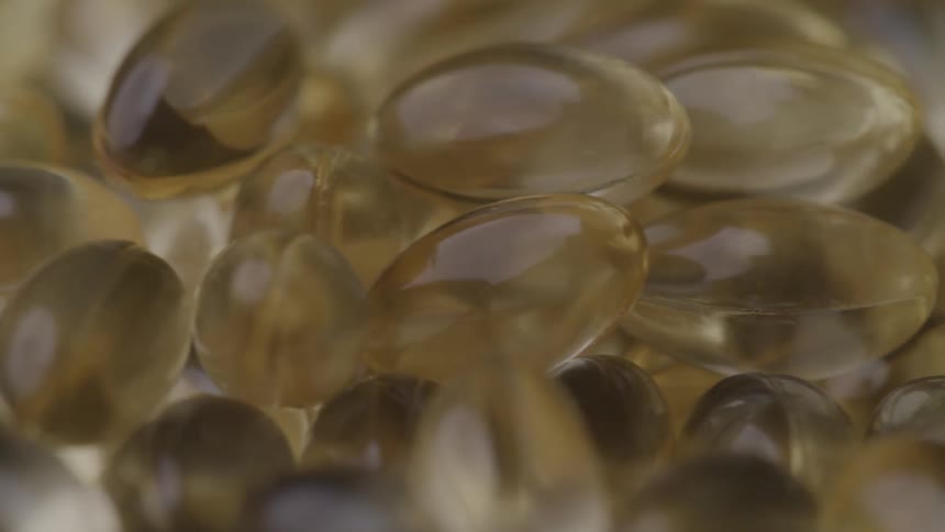 Slightly amber gel capsules form a large mass