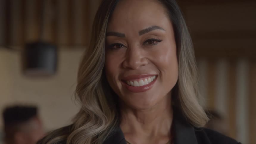 A woman flashes a wide smile