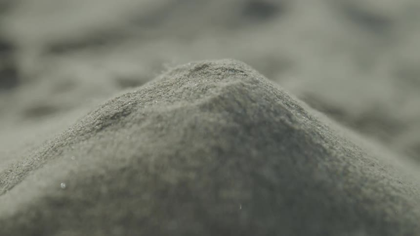 A small mount of sand begins to be blown away by the wind