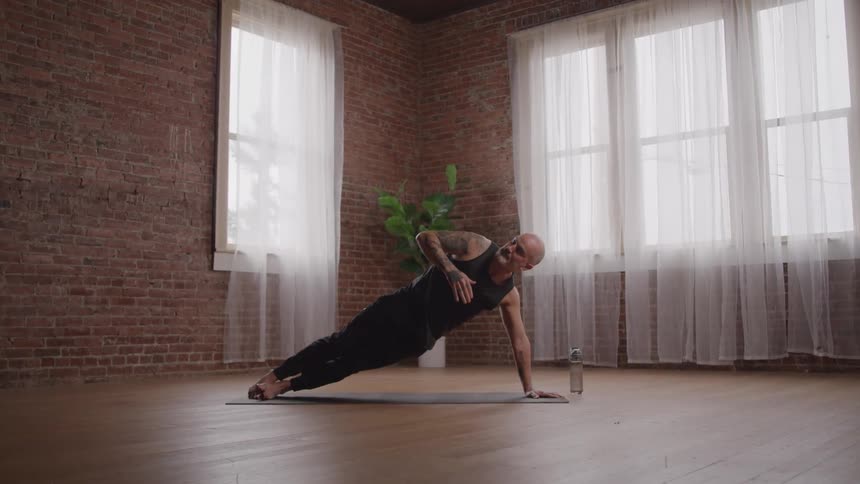 The man is doing yoga alone