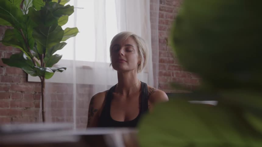 The woman is meditating at home