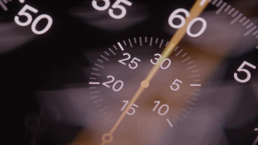 Numerical markers and hand in a closeup of an analog stopwatch