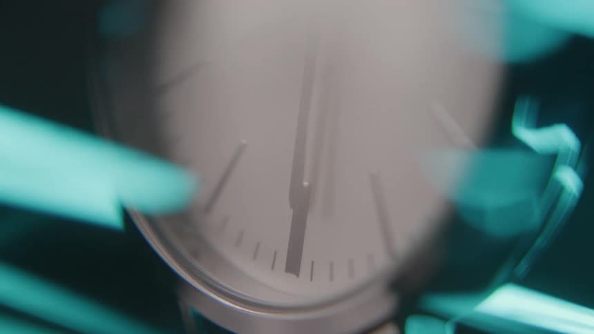 The hands of a clock spin quickly