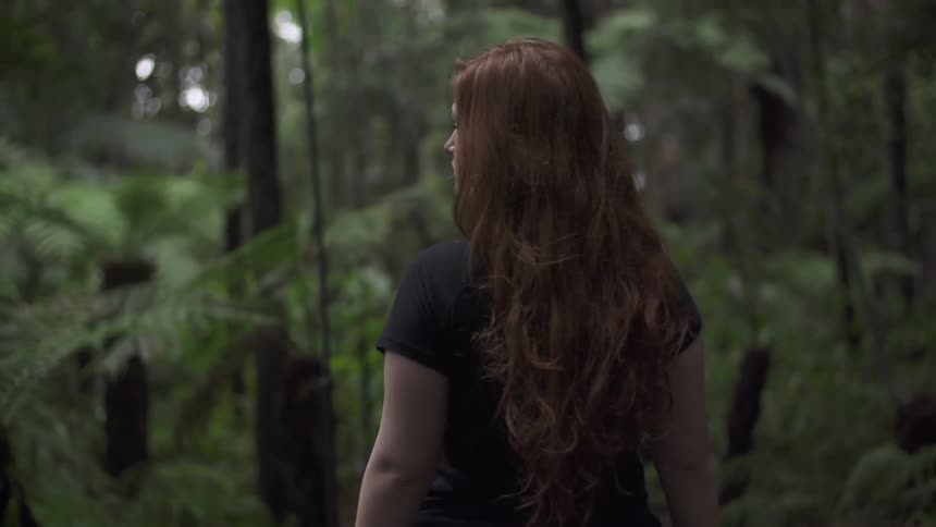 Woman standing in the woods