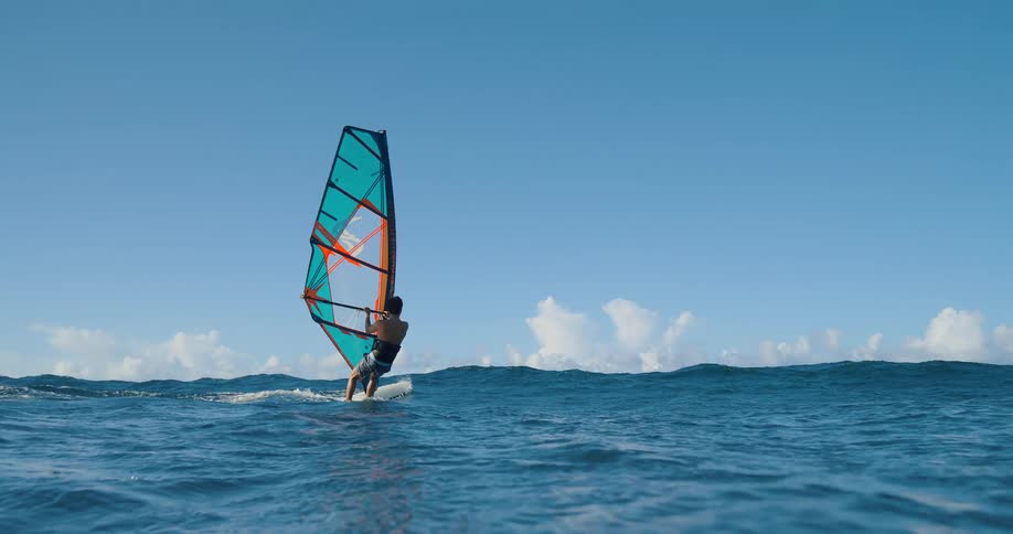 Man windsurfing into the ocean
