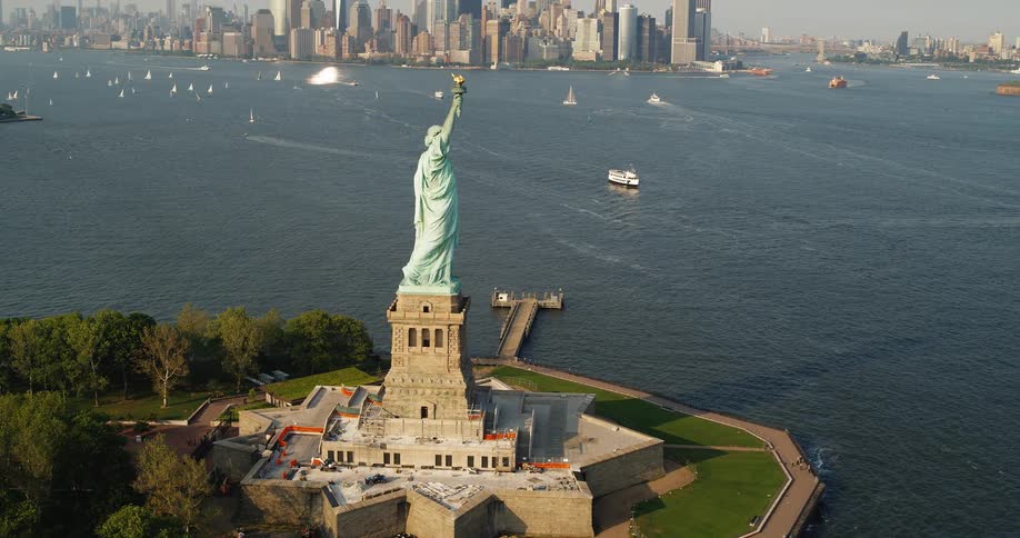 Aerial of the statue of liberty on liberty island the middle of new york harbor