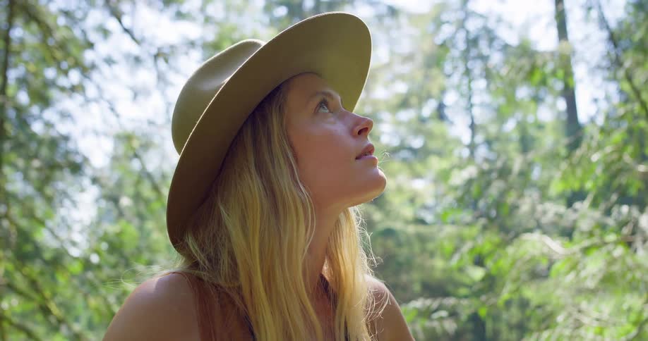 The woman looks around the forest smiling