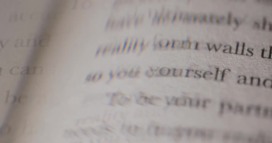 A closeup of a book shows the words can fully love yourself printed on a page