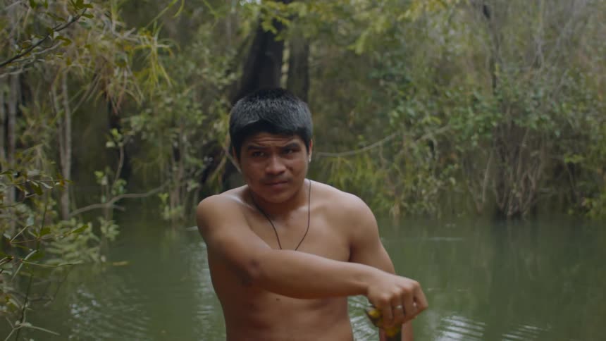 The man paddles through the swamp