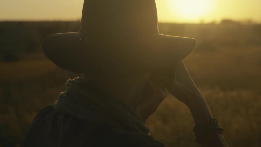 The man takes a photograph of the sunrise