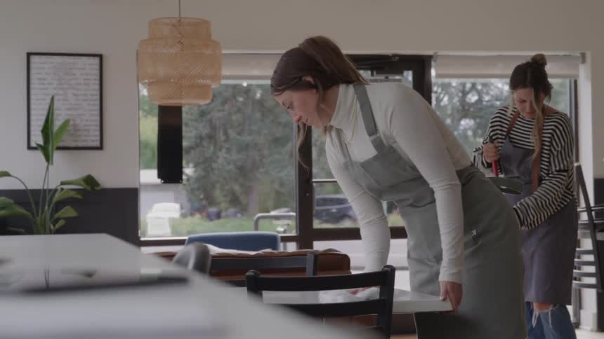 Restaurant workers clean a caf table before service