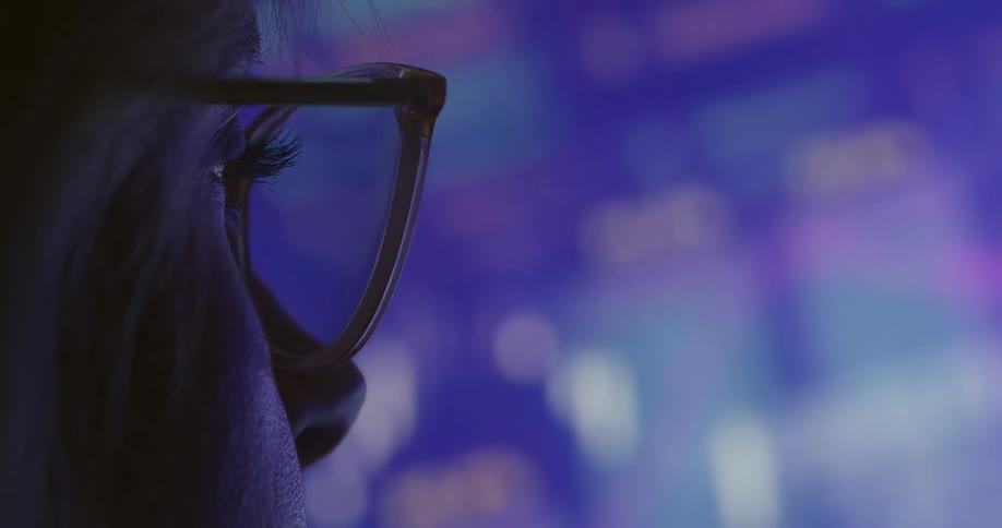 Woman with glasses looking at a color screen